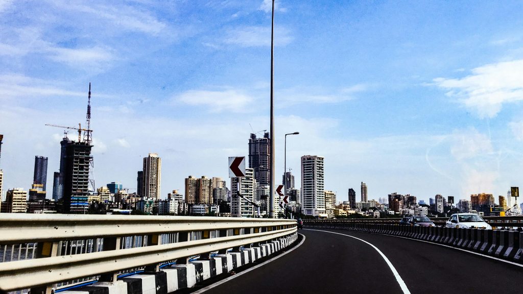 View of Mumbai's skyline featuring modern skyscrapers and a highway.